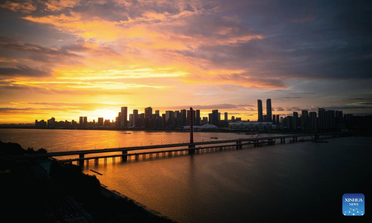 This photo taken on July 22, 2025 shows a view of sunrise accompanied by morning glow along the Qiantang River in Hangzhou, east China's Zhejiang Province. (Xinhua/Jiang Han)