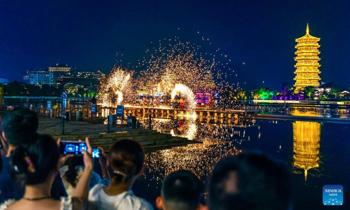 Visitors watch a nighttime show at a theme park in Changsha, central China's Hunan Province, July 22, 2025. (Xinhua)