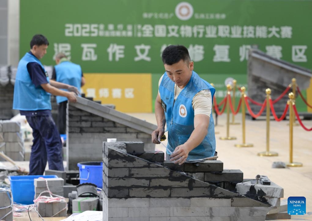 Contestants compete in masonry relic restoration during the 2nd National Cultural Heritage Vocational Skills Competition in Luzhou City, southwest China's Sichuan Province, July 4, 2025. Starting from July 3, the four-day event attracted nearly 300 contestants competing in six categories. (Photo: Xinhua)