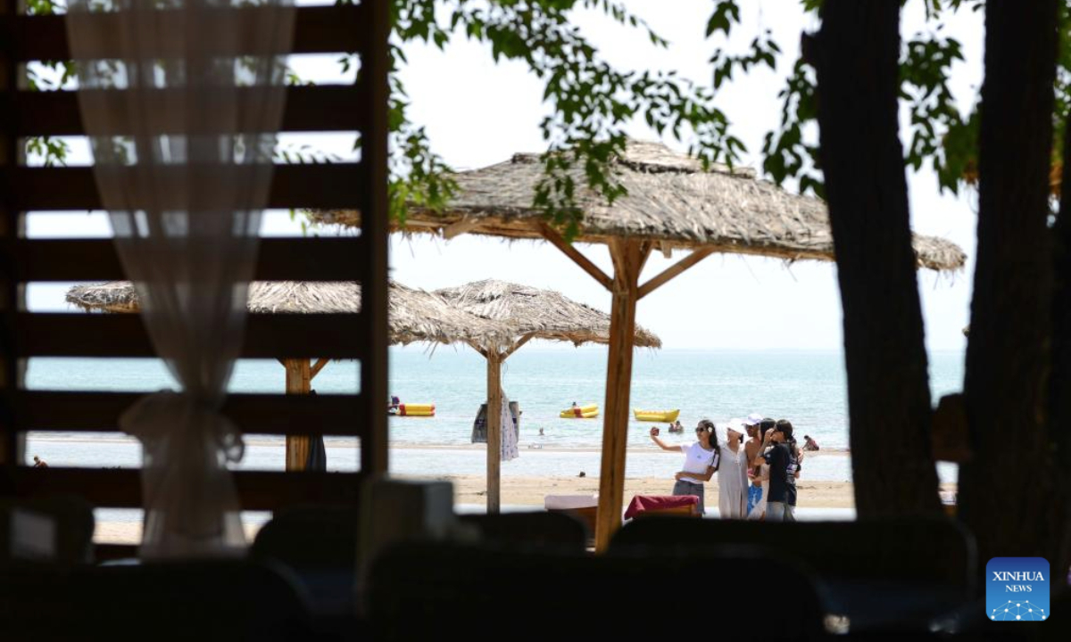 People visit the Kapchagay Reservoir in Konaev, Almaty region, Kazakhstan on July 26, 2025. Recently, the southern part of Kazakhstan, including the city of Almaty, Almaty region and South Kazakhstan region, has been hit by high heat waves. (Xinhua/Li Renzi)