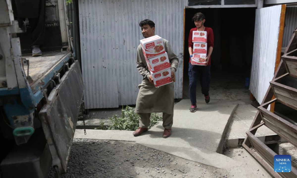 Workers load expired and low-quality food items in Kabul, the capital of Afghanistan, July 15, 2025. Afghan authorities collected and destroyed 65 tons of expired and low-quality food items in the capital Kabul on Tuesday, officials from the Ministry of Public Health said. (Photo by Saifurahman Safi/Xinhua)