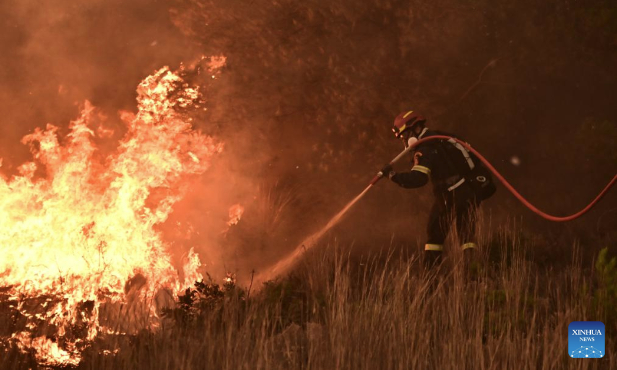 A firefighter battles the flames in Drosopigi, East Attica region of Greece, July 26, 2025. Wildfires broke out in many places across Greece on Saturday, due to the extreme heatwaves recently. The Greek government has requested assistance from the European Union Civil Protection Mechanism to combat the fire. (Photo by krioneri tatiana bolari/Xinhua)