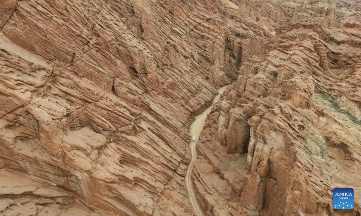 An aerial drone photo shows a vehicle in a canyon near the Duku Highway in northwest China's Xinjiang Uygur Autonomous Region, July 17, 2025. Northwest China's Duku Highway, considered one of the most scenic roads in the country, sees a tourism boom in the summer.

The 561-kilometer highway connects Dushanzi in the north of Xinjiang with Kuqa City in the south, running through varied landscapes that include canyons, glaciers, lakes and grasslands. (Xinhua/Hu Huhu)