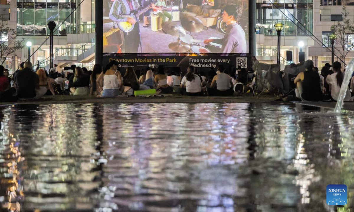 People watch an outdoor film screening during the Downtown Movies in the Park event at David Pecaut Square in Toronto, Canada, on July 16, 2025. Free outdoor screening is scheduled here on every Wednesday evening from July 9 to Aug. 13. (Photo by Zou Zheng/Xinhua)