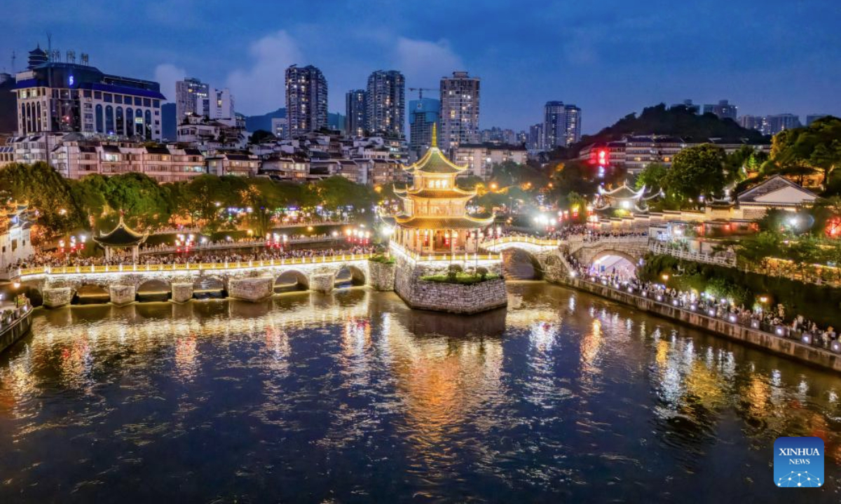 An aerial drone photo taken on July 30, 2025 shows people visiting Jiaxiu tower scenic area in Guiyang, capital of southwest China's Guizhou Province. Guizhou Province, with its cool climate and rich tourism resources, attracts tourists from all over the country during the peak summer travel season. (Xinhua/Liu Xu)
