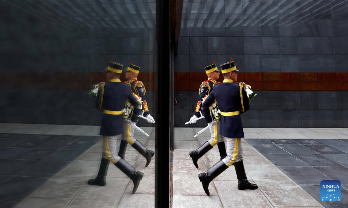 Romanian soldiers carry a wreath during ceremonies marking the European Roma Holocaust Memorial Day at a Holocaust memorial in Bucharest, Romania, July 31, 2025. (Photo by Cristian Cristel/Xinhua)