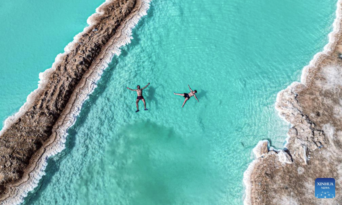 An aerial drone photo taken on July 28, 2025 shows tourists floating on a salt lake at Siwa Oasis in Matrouh Governorate, Egypt. Siwa Oasis lies in Egypt's western desert, some 800 kilometers from Cairo. There are many natural salt lakes on which people can float with no effort due to high salt concentration. (Xinhua/Ahmed Gomaa)