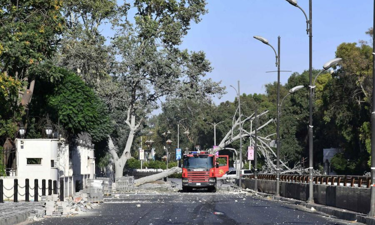A fire truck is seen near a structure damaged in an Israeli airstrike at the Syrian Army General Command headquarters in Damascus, Syria, on July 16, 2025. (Photo by Ammar Safarjalani/Xinhua)