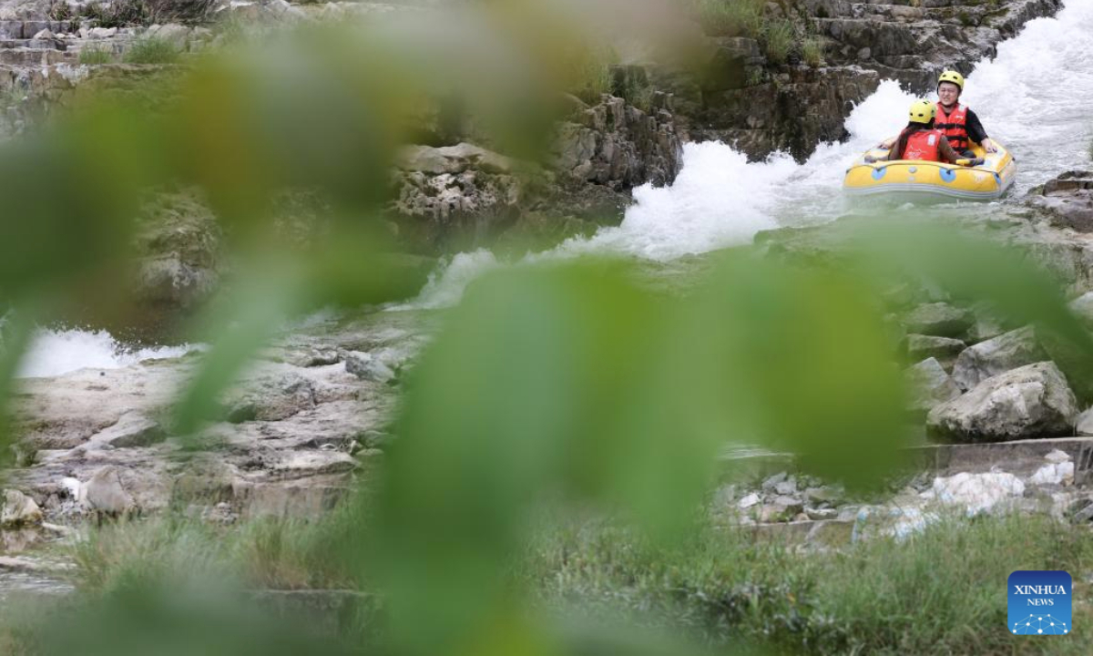 This photo taken on July 21, 2025 shows people rafting in an inflatable boat on Luobei River in Guiding County, southwest China's Guizhou Province. (Xinhua/Ou Dongqu)