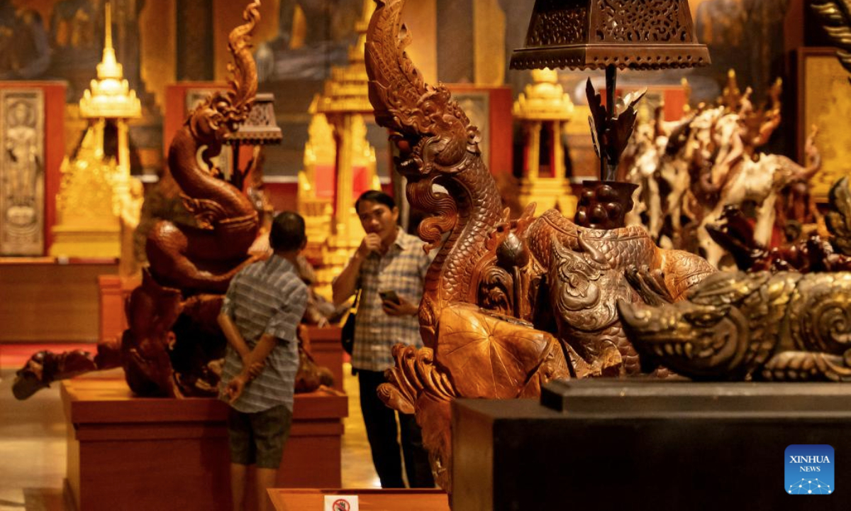 Tourists visit the Lao Art Museum in Vientiane, Laos, July 13, 2025. The Lao Art Museum features an array of traditional Lao woodcarvings, highlighting the intricate craftsmanship that is a cornerstone of the nation's cultural identity. It also provides a platform to showcase creativity across generations, promoting sustainability, environmental awareness, and cultural preservation. (Photo by Kaikeo Saiyasane/Xinhua)
