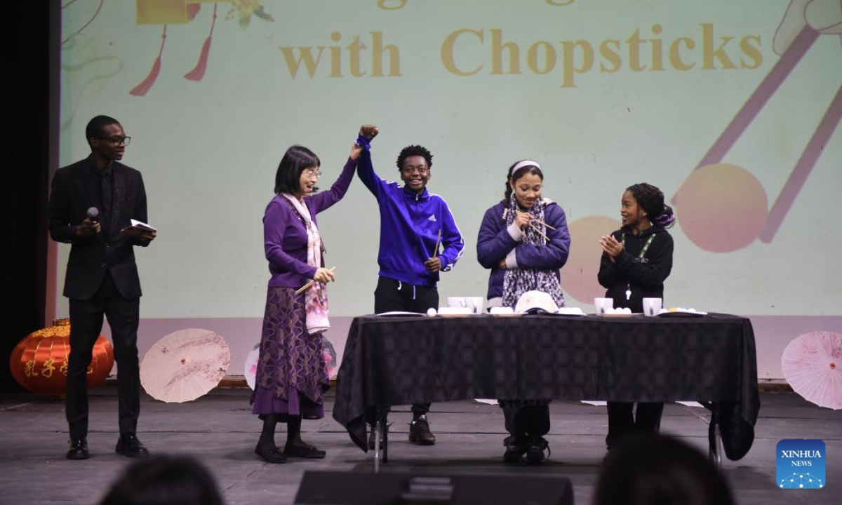 Botswanan students take part in a game of using chopsticks during a Chinese culture show in Gaborone, Botswana, on July 29, 2025. A Chinese culture show was performed on Tuesday at a secondary school with an international enrolment in Gaborone, the capital of Botswana, to offer an immersive journey and highlight the beauty of cultural exchanges. (Photo by Tshekiso Tebalo/Xinhua)