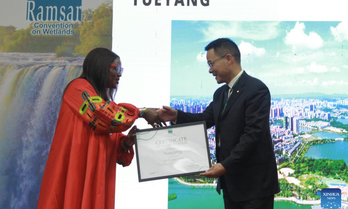 Musonda Mumba (L), secretary general of the Convention on Wetlands, hands over an international wetland city certificate of accreditation to a representative from Yueyang, central China's Hunan Province, in Victoria Falls, Zimbabwe, on July 24, 2025. A total of nine Chinese cities were accredited as international wetland cities on Thursday during the opening of the 15th Meeting of the Conference of the Contracting Parties to the Ramsar Convention on Wetlands (COP15) held in Victoria Falls, bringing the total number of such cities in China to 22, the highest in the world. (Xinhua/Tafara Mugwara)