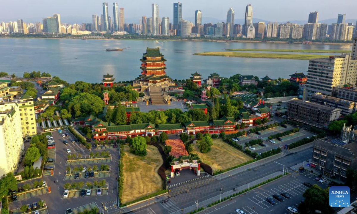An aerial drone photo taken on July 7, 2025 shows a view of the Tengwang Pavilion scenic area in the morning light in Nanchang City, east China's Jiangxi Province. The Tengwang Pavilion, the 29th iteration in its 1,400-year history, features intricately carved beams and vibrantly painted rafters. It stands majestically along the banks of the Ganjiang River, which winds through eastern China's Jiangxi Province. About 90 percent of the scenic area has been open to the public for free as of Jan. 1 this year when a northward expansion project was fully completed. (Xinhua/Liu Jinhai)