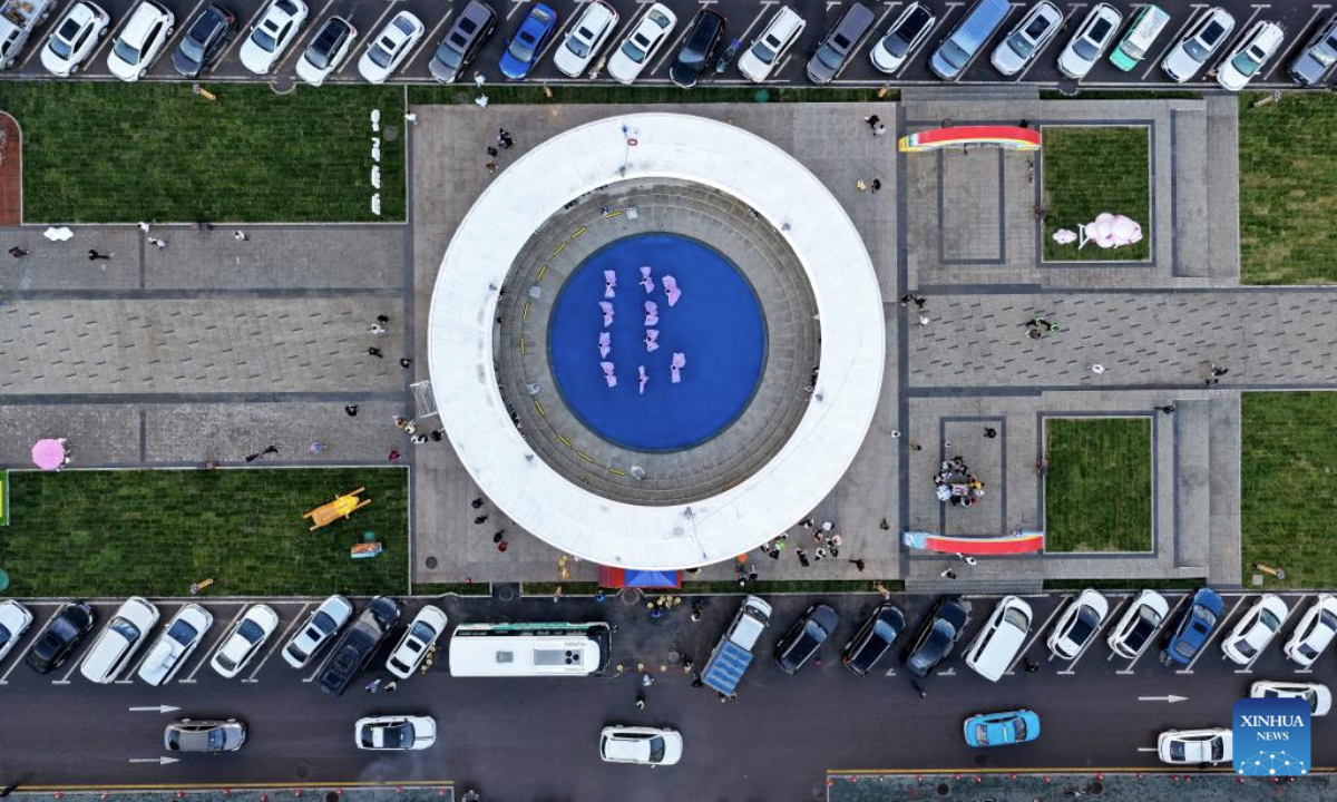 An aerial drone photo taken on July 11, 2025 shows local artists performing for tourists at the Tianma tourism block in Zhaosu County of Ili Kazak Autonomous Prefecture, northwest China's Xinjiang Uygur Autonomous Region. The renovation of the Tianma tourism block in Zhaosu County is a key project in the pairing assistance program of east China's Jiangsu Province for Yili Prefecture. Kicked off on March 11, 2025, the project is now fundamentlly completed.

In addition to offering better experience to tourists, the renovation work also brings more job opportunities to the locals. (Photo by Yang Tianmin/Xinhua)