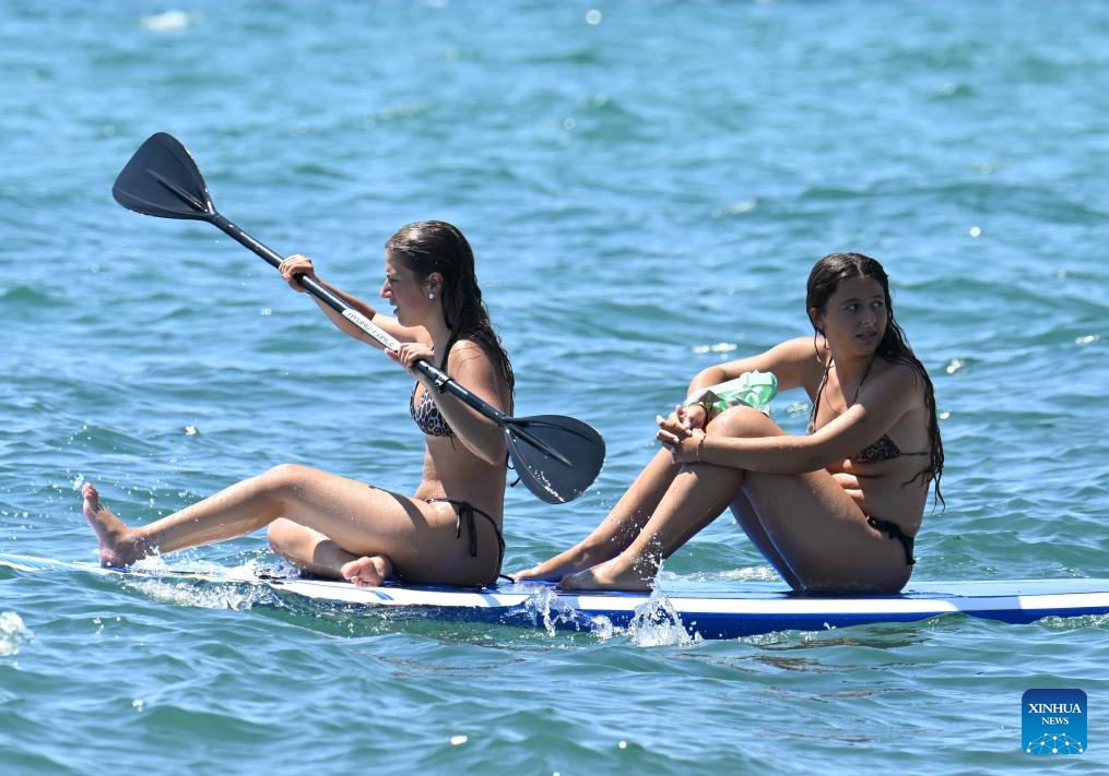 People on a paddle board enjoy the sea during a heatwave in Ladispoli, Rome, Italy, July 5, 2025. (Photo: Xinhua)