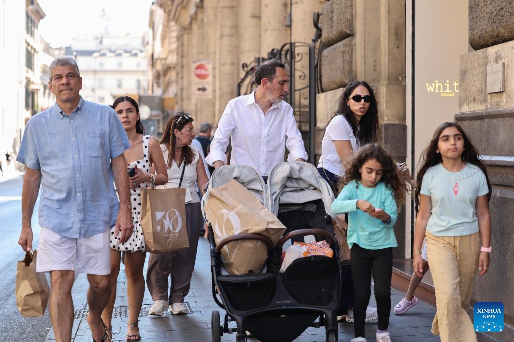 People walk with shopping bags in Rome, Italy, July 5, 2025. Italy's summer sales started on Saturday, running between six and eight weeks. (Photo: Xinhua)