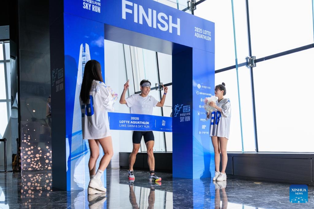 A participant crosses the finish line during the 2025 Lotte Aquathlon competition including Lake Swim and Sky Run, in Seoul, South Korea, July 6, 2025. The competition attracted more than 800 participants. (Photo: Xinhua)