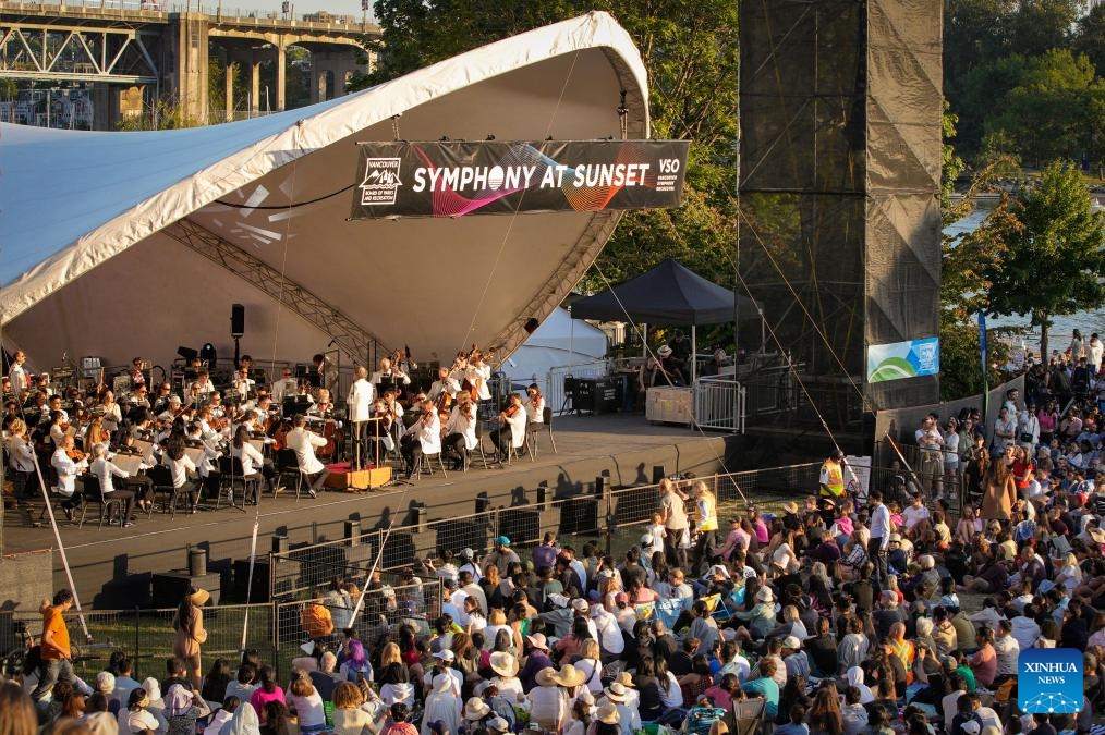 Musicians of the Vancouver Symphony Orchestra perform during the Symphony at Sunset concert at Sunset Beach Park in Vancouver, British Columbia, Canada, July 5, 2025. (Photo: Xinhua)