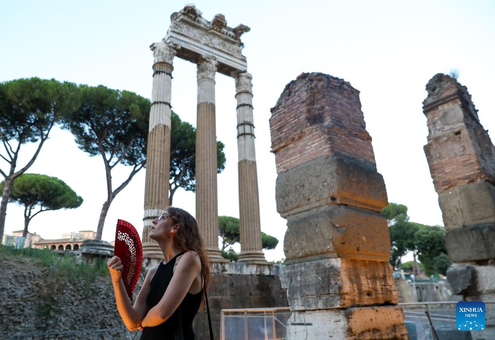 A woman visits the Imperial Forum during a night tour in Rome, Italy, July 5, 2025. The Imperial Forum has opened to visitors on every Friday, Saturday and Sunday evening since June 20 and will last until September 28. (Photo: Xinhua)