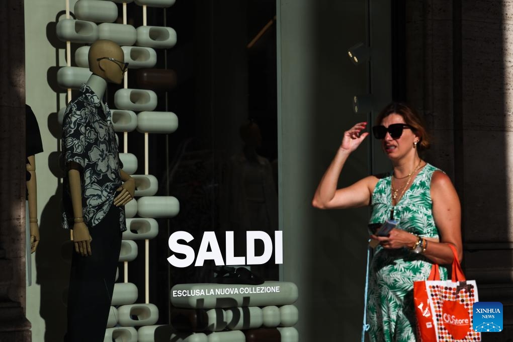 A woman walks past a shop window in Rome, Italy, July 5, 2025. Italy's summer sales started on Saturday, running between six and eight weeks. (Photo: Xinhua)