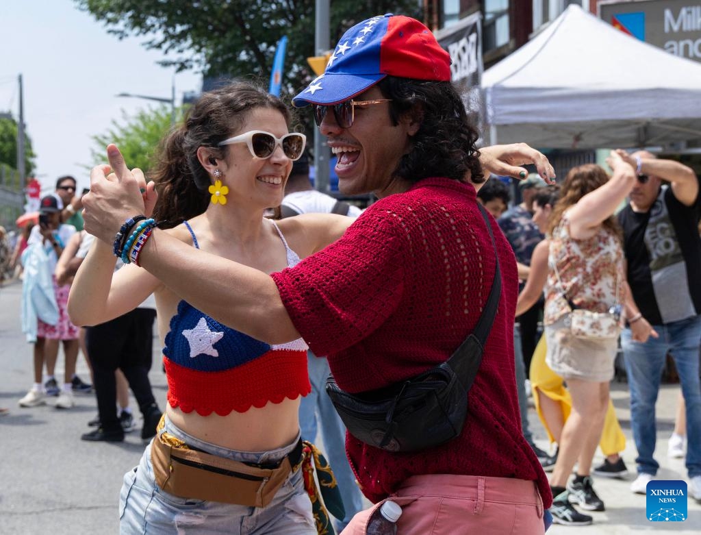 People dance on the street during the 2025 Salsa on St. Clair Street Festival in Toronto, Canada, on July 5, 2025. As one of the largest Latino-themed cultural celebrations in Canada, the two-day annual festival kicked off here on Saturday. (Photo: Xinhua)