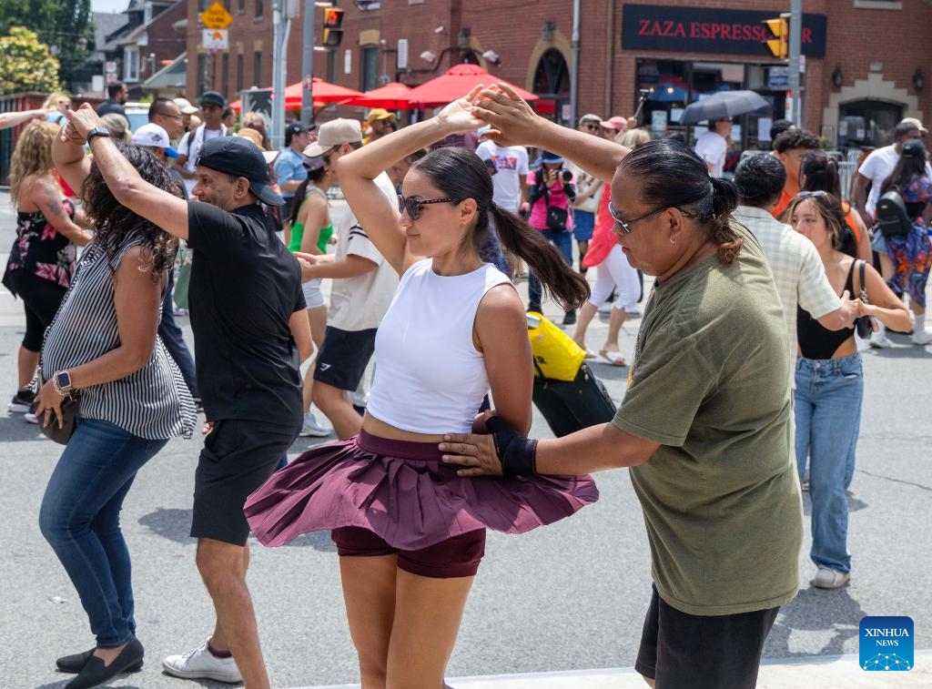 People dance on the street during the 2025 Salsa on St. Clair Street Festival in Toronto, Canada, on July 5, 2025. As one of the largest Latino-themed cultural celebrations in Canada, the two-day annual festival kicked off here on Saturday. (Photo: Xinhua)