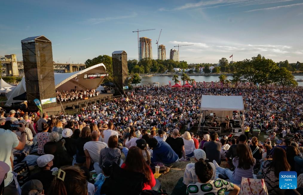 People watch a music performance by the Vancouver Symphony Orchestra during the Symphony at Sunset concert at Sunset Beach Park in Vancouver, British Columbia, Canada, July 5, 2025. (Photo: Xinhua)