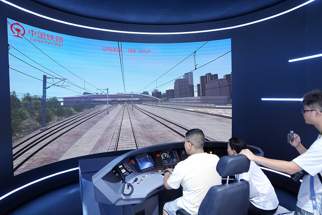 A visitor experiences simulated driving of a Fuxing high-speed train at the 17th China International Modern Railway Technology and Equipment Exhibition on July 9, 2025. The exhibition, which kicked off in Beijing on July 8, showcases the latest railway technologies and equipment from around the world. Photo: VCG