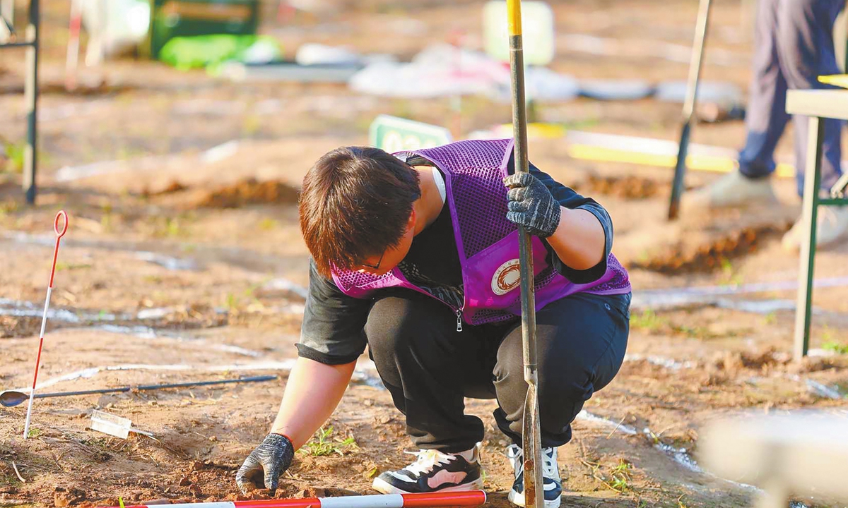 Wu Xiaojun works at a simulated excavation site during the competition. Photo: Courtesy of National Cultural Heritage Administration