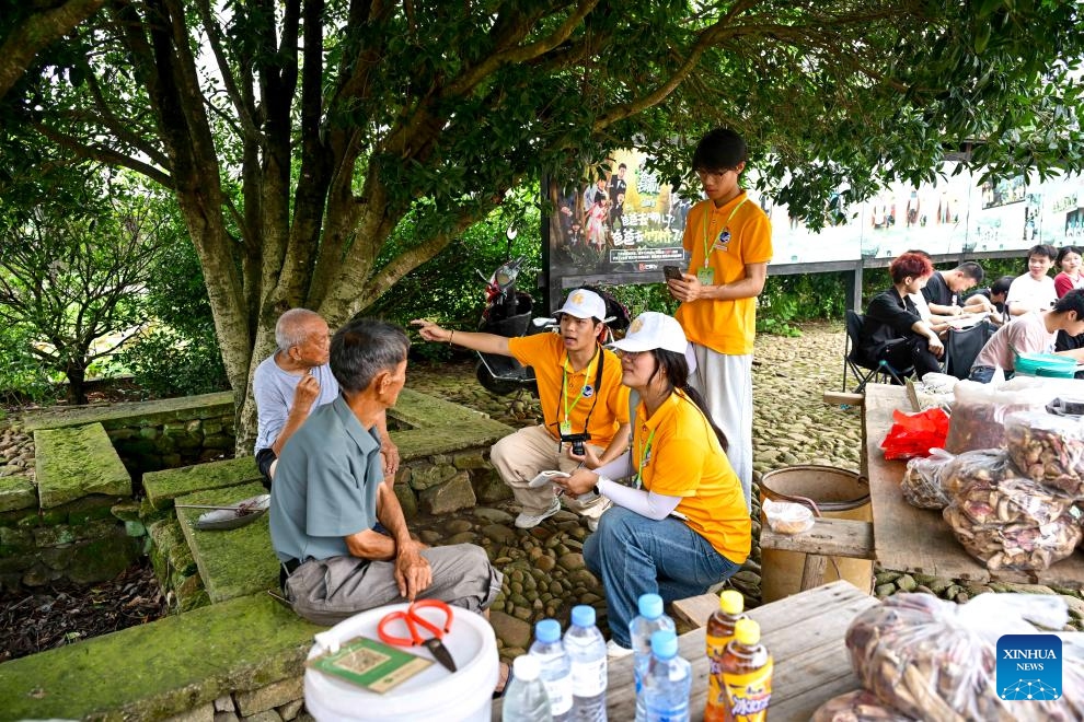 College students conduct research on the protection of historical buildings and the development of cultural tourism in Zhuqiao Village, Jinxi County of Fuzhou, east China's Jiangxi Province, July 9, 2025. Jinxi County, with centuries-long history, still preserves over 100 ancient villages dating back to the Ming and Qing dynasties (1368-1911), which has won the county fame as an ancient village museum without bounding walls. Zhuqiao is a prominent representative among the villages, featuring 109 existing ancient buildings from the Ming and Qing dynasties. (Photo: Xinhua)