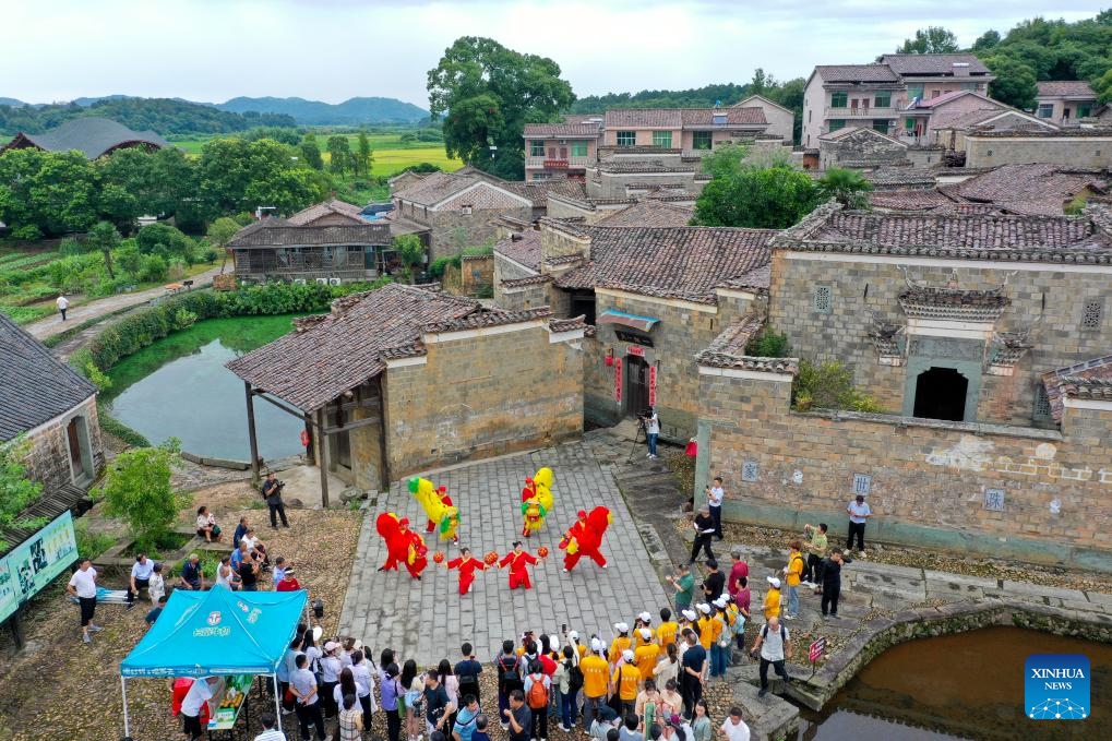 An aerial drone photo taken on July 9, 2025 shows tourists watching a folk performance in Zhuqiao Village, Jinxi County of Fuzhou, east China's Jiangxi Province. Jinxi County, with centuries-long history, still preserves over 100 ancient villages dating back to the Ming and Qing dynasties (1368-1911), which has won the county fame as an ancient village museum without bounding walls. Zhuqiao is a prominent representative among the villages, featuring 109 existing ancient buildings from the Ming and Qing dynasties. (Photo: Xinhua)