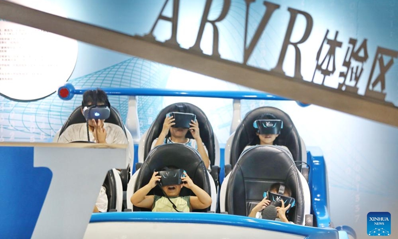 Children try AR and VR devices at a science and technology hall in Jiaxing City, east China's Zhejiang Province, July 12, 2025. Children across the country are enriching their summer vacations through colorful activities. (Photo: Xinhua)