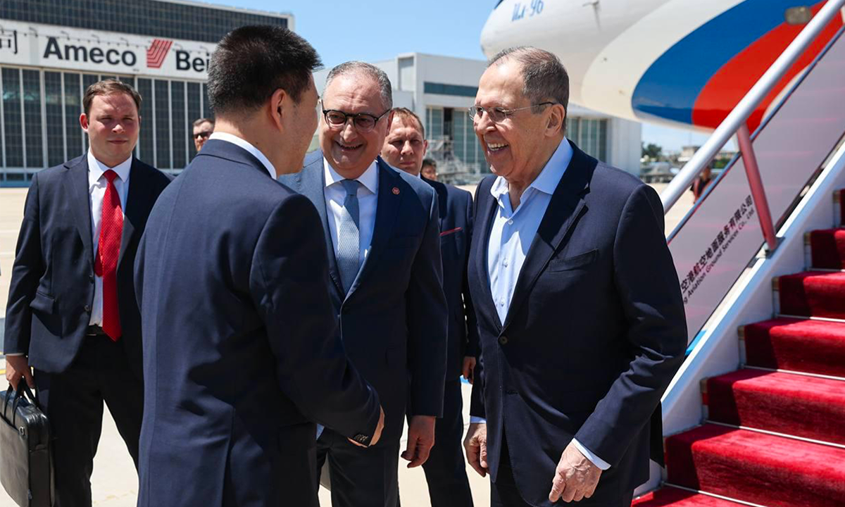 Russian Foreign Minister Sergei Lavrov, right, shakes hands with a Chinese official upon his arrival at an international airport outside Beijing, China, on July 13, 2025, to participate in the Meeting of the Council of the Ministers of Foreign Affairs of the Shanghai Cooperation Organization Member States. Photo: VCG