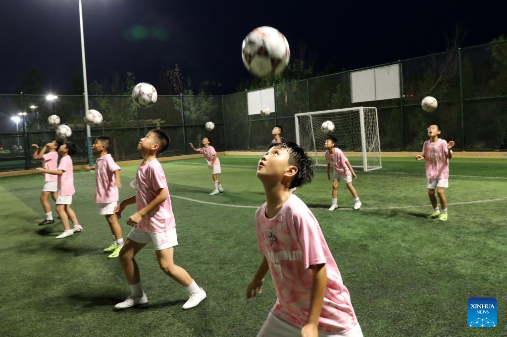 Children attend a nighttime training at a football club in Boxing County, Binzhou City of east China's Shandong Province, July 10, 2025. Children across the country are enriching their summer vacations through colorful activities. (Photo: Xinhua)