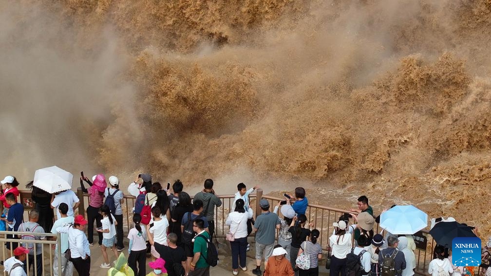A drone photo shows people visiting the Hukou Waterfall on the Yellow River in Jixian County, north China's Shanxi provinces, July 12, 2025. The waterfall is located on the border area between north China's Shanxi and northwest China's Shaanxi provinces. (Photo: Xinhua)