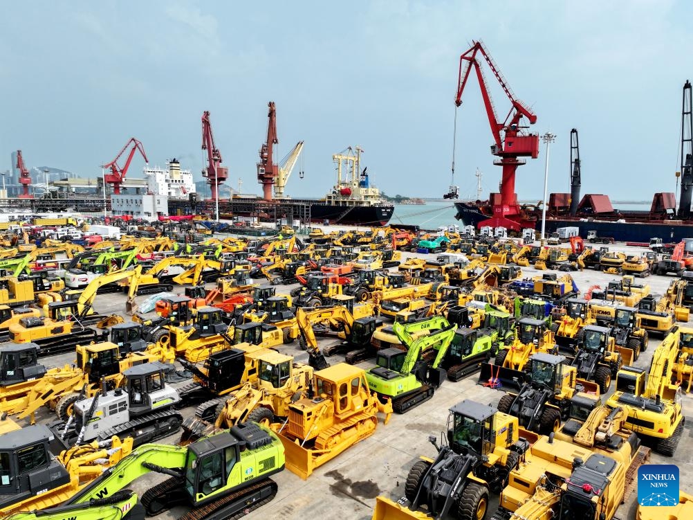 This aerial photo taken on July 13, 2025 shows engineering mechanical products for export rallied at a port in Lianyungang City, east China's Jiangsu Province. China's maritime industry now handles nearly one-third of global maritime shipping volume, according to the 2025 China Maritime Day Forum held in the coastal town of Boao in south China's Hainan Province on Friday. China's booming marine economy is driving sustained and stable growth in global trade and development. (Photo: Xinhua)