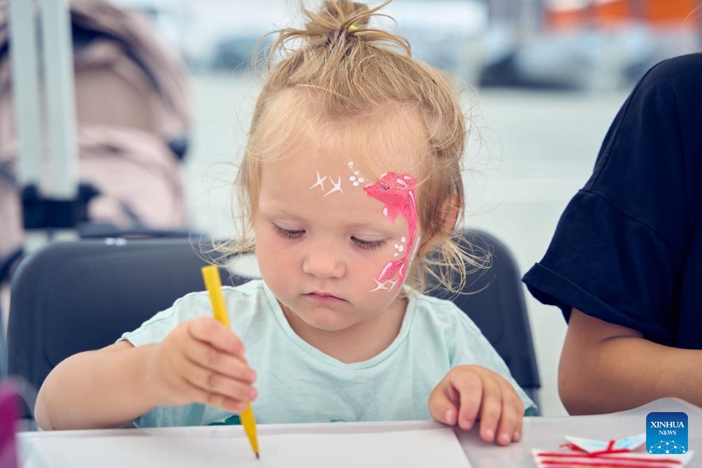 A girl with a dolphin pattern painted on her face attends a Fisherman's Day celebration in Vladivostok, Russia, July 13, 2025. The Fisherman's Day is observed across Russia on the second Sunday of July. (Photo: Xinhua)
