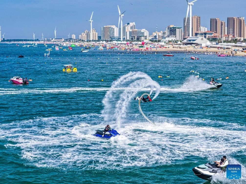 An aerial drone photo taken on July 12, 2025 shows tourists having fun at a scenic spot in Rongcheng City, east China's Shandong Province. With heatwaves hitting some Chinese provinces and regions in recent days, the scorching temperature has fueled a cooling economy boom. (Photo: Xinhua)