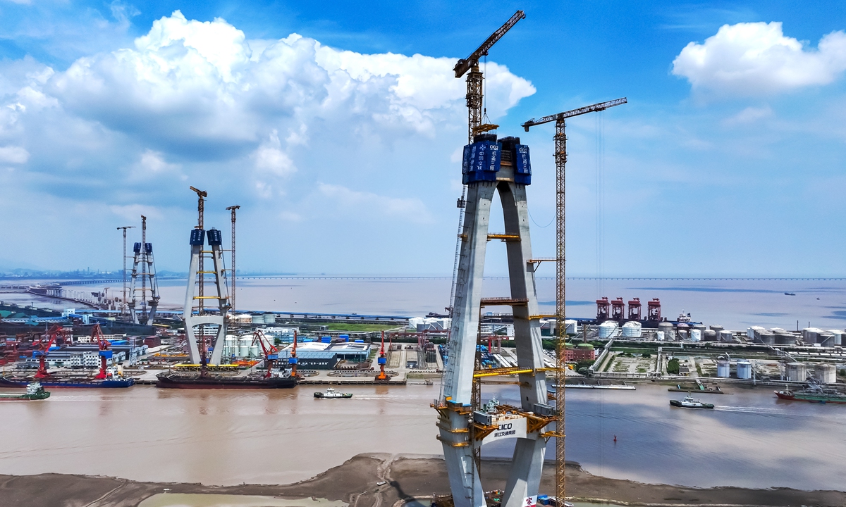 Workers install steel frames at a construction site for a bridge in Ningbo, East China's Zhejiang Province on July 18, 2025. It will be the world's largest three-tower asymmetric cable-stayed bridge, at 1,730 meters long. The main tower will be 223 meters high. Photo: VCG