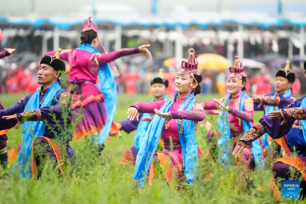 People perform during the opening ceremony of a Nadam fair held in Xilinhot, Xilin Gol League, north China's Inner Mongolia Autonomous Region, July 19, 2025. The Nadam Fair opened here on Saturday, featuring night parade performances, intangible cultural heritage handicraft making events, and ethnic game experiences. The fair has effectively invigorated the summer tourism market, and attracted tourists to experience the charm of grassland culture. (Photo: Xinhua)
