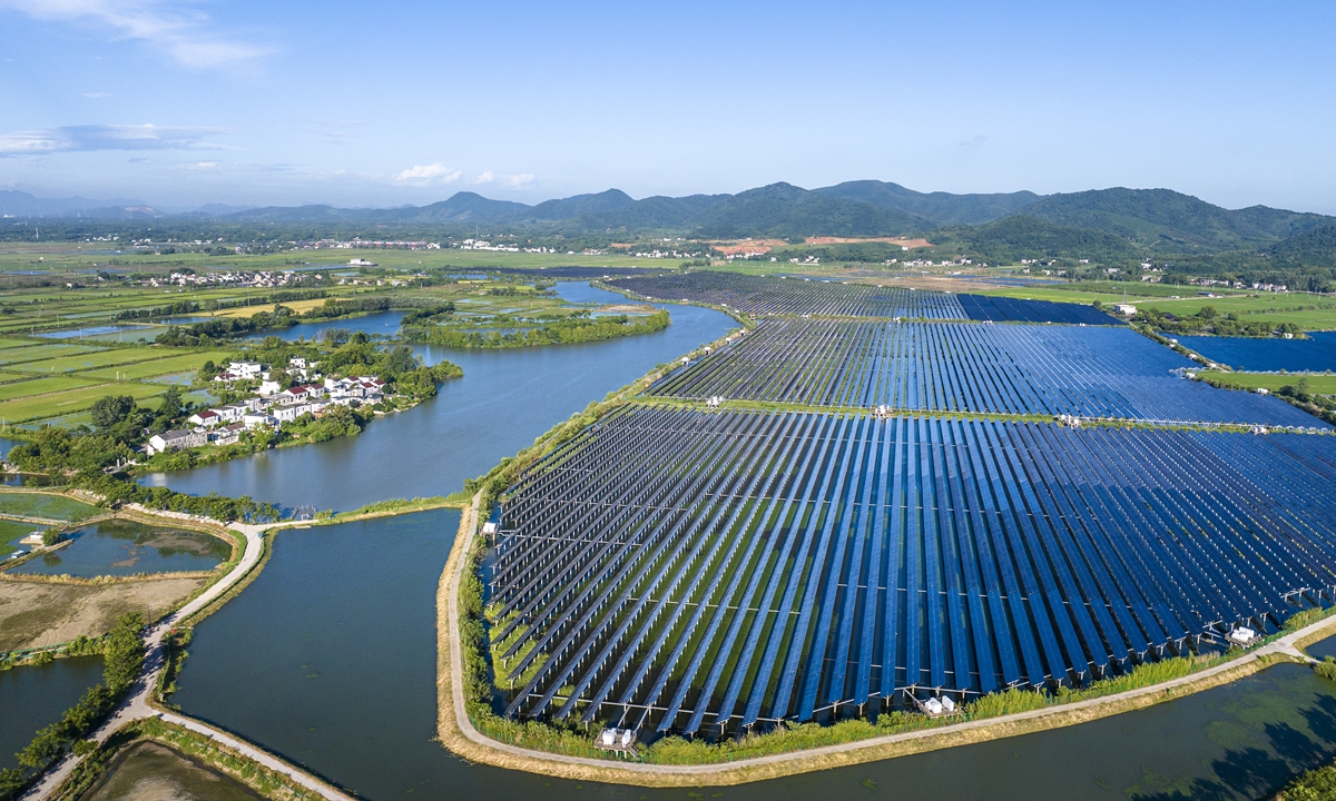 A fishery-solar hybrid photovoltaic power station in Wuhu, East China's Anhui Province blends with surrounding farmland and water, forming a vivid green landscape on July 20, 2025. Wuhu promotes solar and wind energy development, while the State Grid Wuhu Power Supply Co boosts grid infrastructure and standardizes grid access. These efforts support energy conservation and deliver both economic and ecological benefits. Photo: VCG