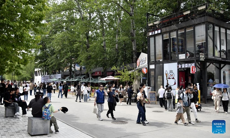 Tourists visit the 798 Art Zone in Beijing, capital of China, May 4, 2025. Built on the site of an abandoned factory complex, the 798 Art Zone, with age-old auburn bricks of its facade that are reminiscent of its industrial past, becomes a renowned place for museums and galleries of contemporary art. The art zone recorded 12.57 million visits in 2024. (Photo: Xinhua)