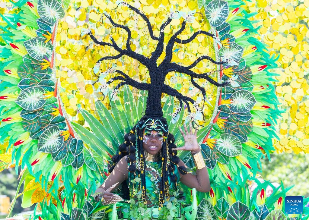 A dressed-up girl dances with her float during the Junior Carnival Parade of the 2025 Toronto Caribbean Carnival in Toronto, Canada, on July 19, 2025. The annual event kicked off here on Saturday with thousands of young participants in vibrant costumes celebrating Caribbean culture with music and dance. (Photo: Xinhua)