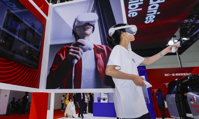 A visitor tries a smart product equipped with Snapdragon processor at the Qualcomm booth in the Digital Technology Chain area of the third China International Supply Chain Expo (CISCE) in Beijing, capital of China, July 19, 2025. The 2025 CISCE, scheduled from July 16 to 20, opened to general public on Saturday. Photo: Xinhua