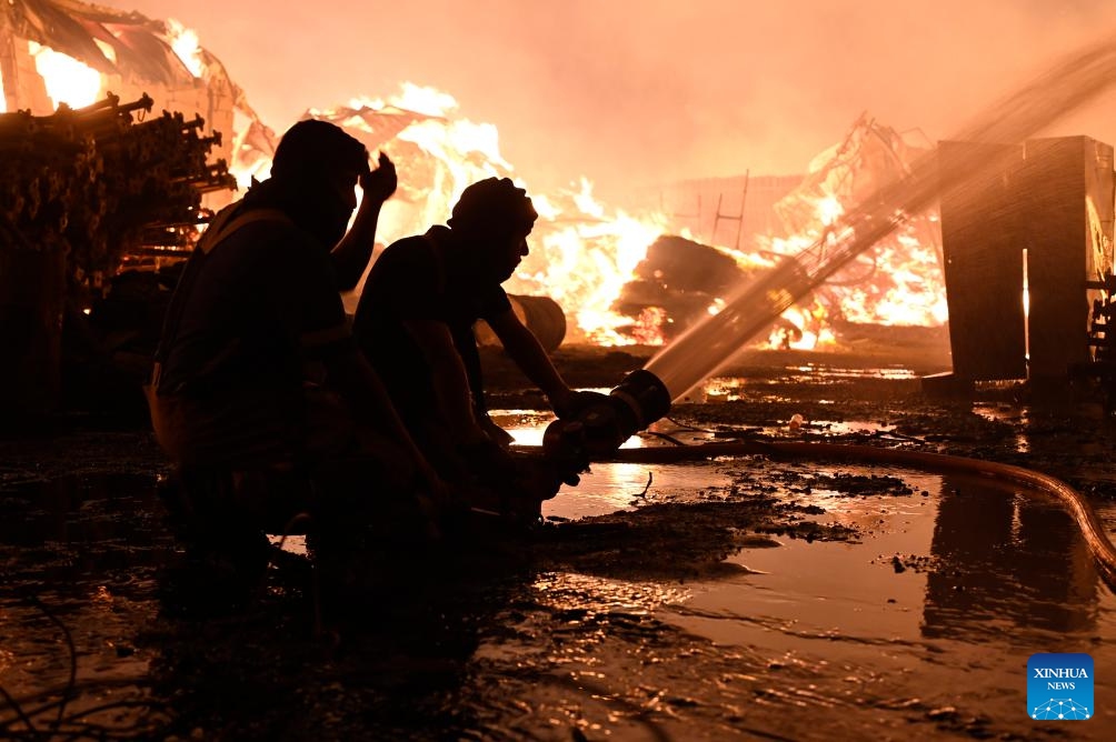 Firefighters attempt to put out a fire that engulfed a wood warehouse in Jahra Governorate, Kuwait, on July 18, 2025. (Photo: Xinhua)