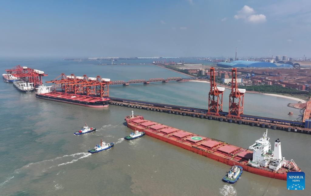 A drone photo taken on July 18, 2025 shows a cargo ship, assisted by tugboats, berthing at the ore terminal of Caofeidian Port Area in Tangshan Port in Tangshan, north China's Hebei Province. The cargo throughput at Tangshan Port reached 433.56 million tonnes in the first half of 2025, up 0.75 percent year on year, according to port authorities. (Photo: Xinhua)