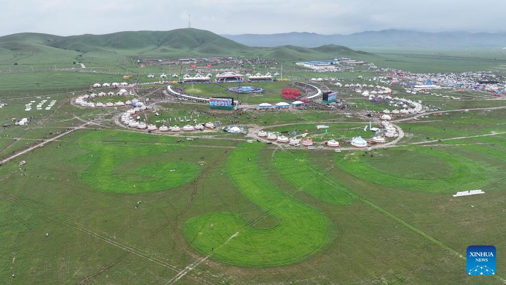An aerial drone photo taken on July 19, 2025 shows the opening ceremony of a Nadam fair held in Xilinhot, Xilin Gol League, north China's Inner Mongolia Autonomous Region. The Nadam Fair opened here on Saturday, featuring night parade performances, intangible cultural heritage handicraft making events, and ethnic game experiences. The fair has effectively invigorated the summer tourism market, and attracted tourists to experience the charm of grassland culture. (Photo: Xinhua)