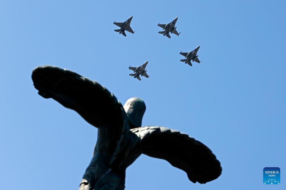 Military airplanes fly over the Statue of Air Heroes during celebrations of the Romanian Aviation and Air Force Day in Bucharest, Romania, July 20, 2025. (Photo: Xinhua)
