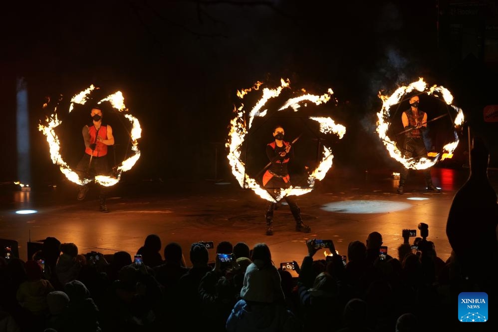 Performers present a fire show during the Winter in the City event in Canberra, Australia, on July 19, 2025. Wrapped up here on Saturday, the two-week event enlivened Canberra's city center with nightly fire shows, acrobatic performances and interactive musical theatre, creating a vibrant winter festive atmosphere. Besides the entertainment, over 30 food stalls representing cuisines from around the world offered visitors a diverse culinary experience. (Photo: Xinhua)