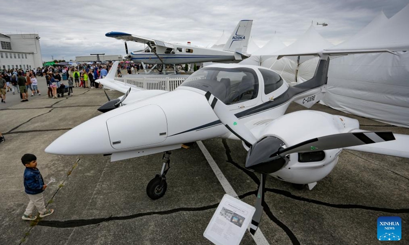 A child takes a closer look at an aircraft on display at the 2025 Boundary Bay Airshow in Delta, British Columbia, Canada, July 19, 2025. The annual airshow opened here on Saturday, featuring aerobatic performances and static displays of both modern and vintage airplanes, attracting large crowds of aviation enthusiasts. (Photo: Xinhua)